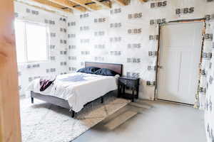 Bedroom featuring concrete flooring