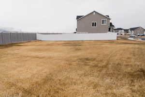 View of yard featuring fence and a residential view