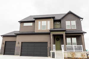 View of front facade featuring an attached garage, concrete driveway, brick siding, and a shingled roof