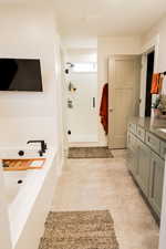 Bathroom featuring a shower stall and vanity