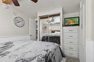 Bedroom featuring vaulted ceiling, ceiling fan, and a closet