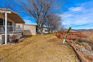 View of yard featuring a deck with mountain view