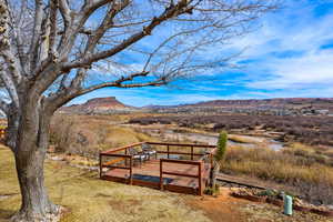 View of yard with a deck with mountain view