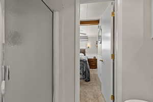 Bathroom with an enclosed shower, connected bathroom, and beam ceiling