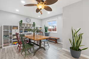 Dining room with light wood-type flooring, ceiling fan, baseboards, and recessed lighting