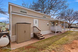 Rear view of house with central AC and a yard