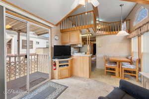 Kitchen with hanging light fixtures, light countertops, and a healthy amount of sunlight