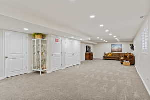 Interior space featuring baseboards, visible vents, carpet flooring, and recessed lighting