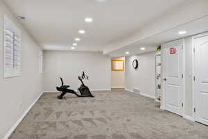 Workout room with light carpet, visible vents, baseboards, and recessed lighting