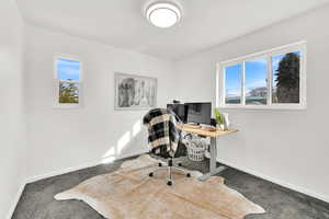 Office space with a healthy amount of sunlight, carpet flooring, and baseboards