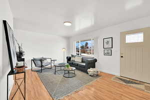 Living room featuring a new window, new front door and an airy flow