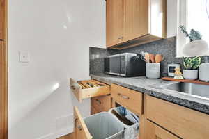 Custom higher end cabinetry with solid wood boxes, custom pull outs, a trash can drawer properly placed next to the sink, and a 2 layered sliding silverware drawer on premium drawer guides.