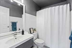 Full bathroom featuring vanity and toilet