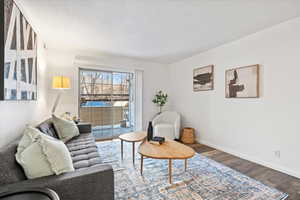 Living area with baseboards and dark wood finished floors