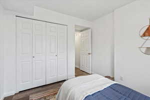 Bedroom featuring a closet and dark wood finished floors