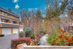 Exterior space featuring a garage, driveway, and a balcony