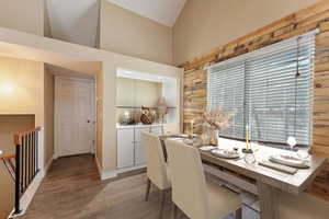 Dining space featuring lofted ceiling, and wood finished floors