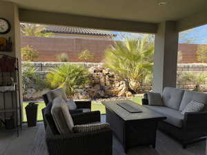 View of patio with outdoor lounge area and fence