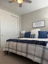 Bedroom featuring a closet, carpet flooring, and a ceiling fan