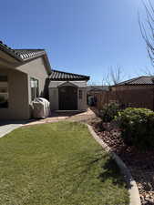 View of yard featuring an outdoor structure and fence