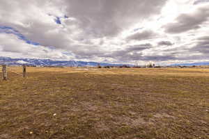 View of yard featuring a rural view, fence, and a mountain view