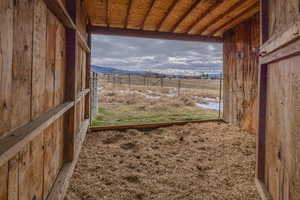 View looking south with mountain views from inside teh barn