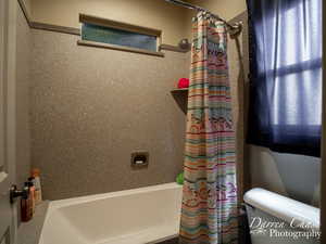 Bathroom with shower / bath combo and toilet