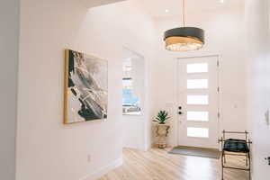 Foyer featuring light wood-type flooring and baseboards