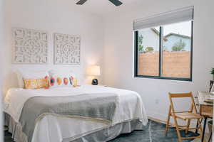 Bedroom with a ceiling fan and baseboards