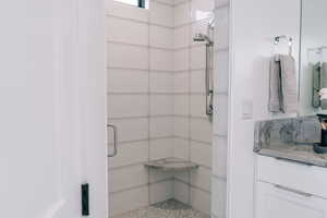 Bathroom with vanity and a shower with shower door