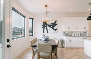 Dining area with recessed lighting, visible vents, a chandelier, light wood-type flooring, and baseboards