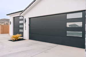 Garage featuring a mountain view and driveway