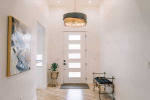 Foyer entrance featuring light wood-type flooring and baseboards