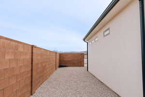 View of yard featuring a fenced backyard and a patio