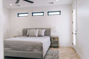 Bedroom featuring baseboards, visible vents, wood finished floors, and recessed lighting