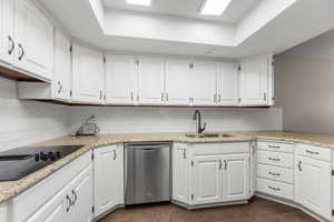 Kitchen featuring a sink, white cabinets, and stainless steel dishwasher