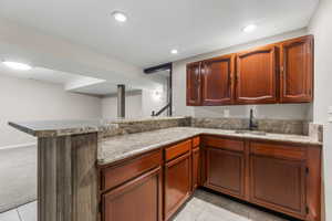 Kitchenette/Bar featuring recessed lighting, a sink, and light tile patterned floors