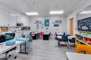 Home office featuring light hardwood / wood-style flooring and sink