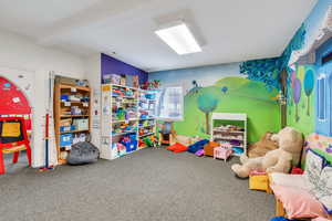 Playroom featuring carpet flooring and beam ceiling