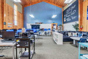 Interior space featuring high vaulted ceiling, wood walls, and wood ceiling