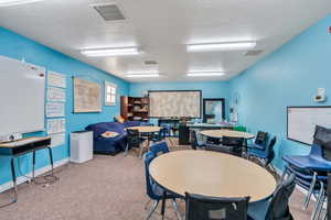 Playroom featuring carpet and a textured ceiling