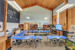 Rec room with carpet flooring, high vaulted ceiling, and wooden ceiling