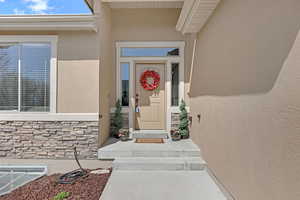 View of exterior entry with stucco siding