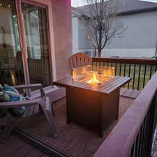 View of wooden balcony with an outdoor fire pit and a deck