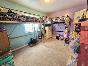 Bedroom with carpet and baseboards