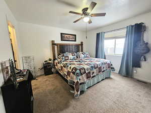 Bedroom with carpet floors, visible vents, ceiling fan, a textured ceiling, and baseboards