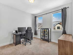 Office featuring light carpet and mountain views