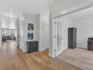 Hallway featuring light wood LVP floors, office area