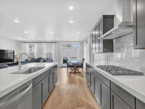 Kitchen featuring appliances with stainless steel finishes, open floor plan, and white countertops