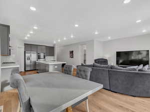 Dining room with light wood-style LVP flooring and recessed lighting